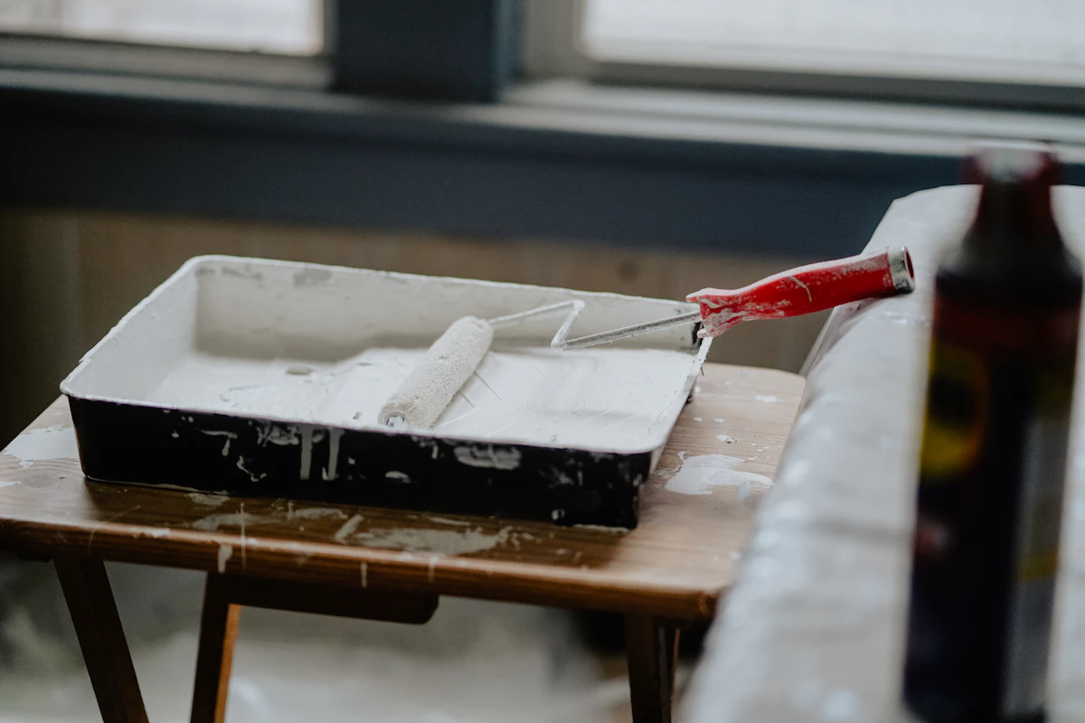 Paint roller and tray on a work table during a home renovation